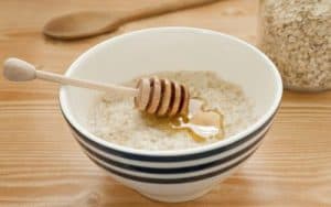 a bowl of oatmeal with honey as a pureed food