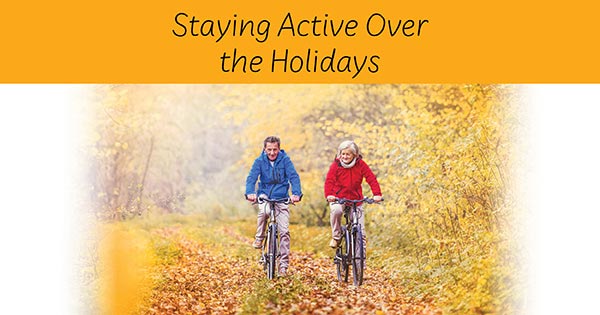 man and woman biking to staying active over the holidays