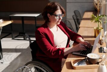 woman in wheelchair on computer
