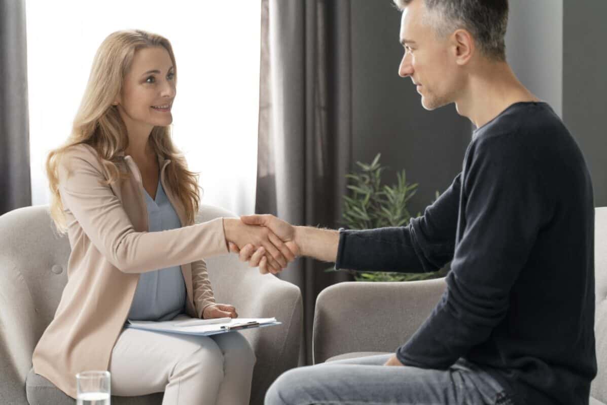 man shaking hands with a therapist