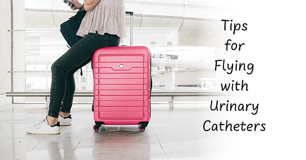 Woman with her pink luggage in an airport flying with urinary catheters