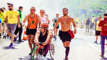 people participating in a spina bifida awareness race including a man in a wheelchair